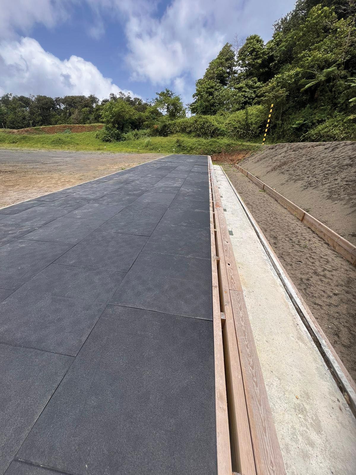 Close-up of ballistic rubber tile joints on an outdoor firing lane